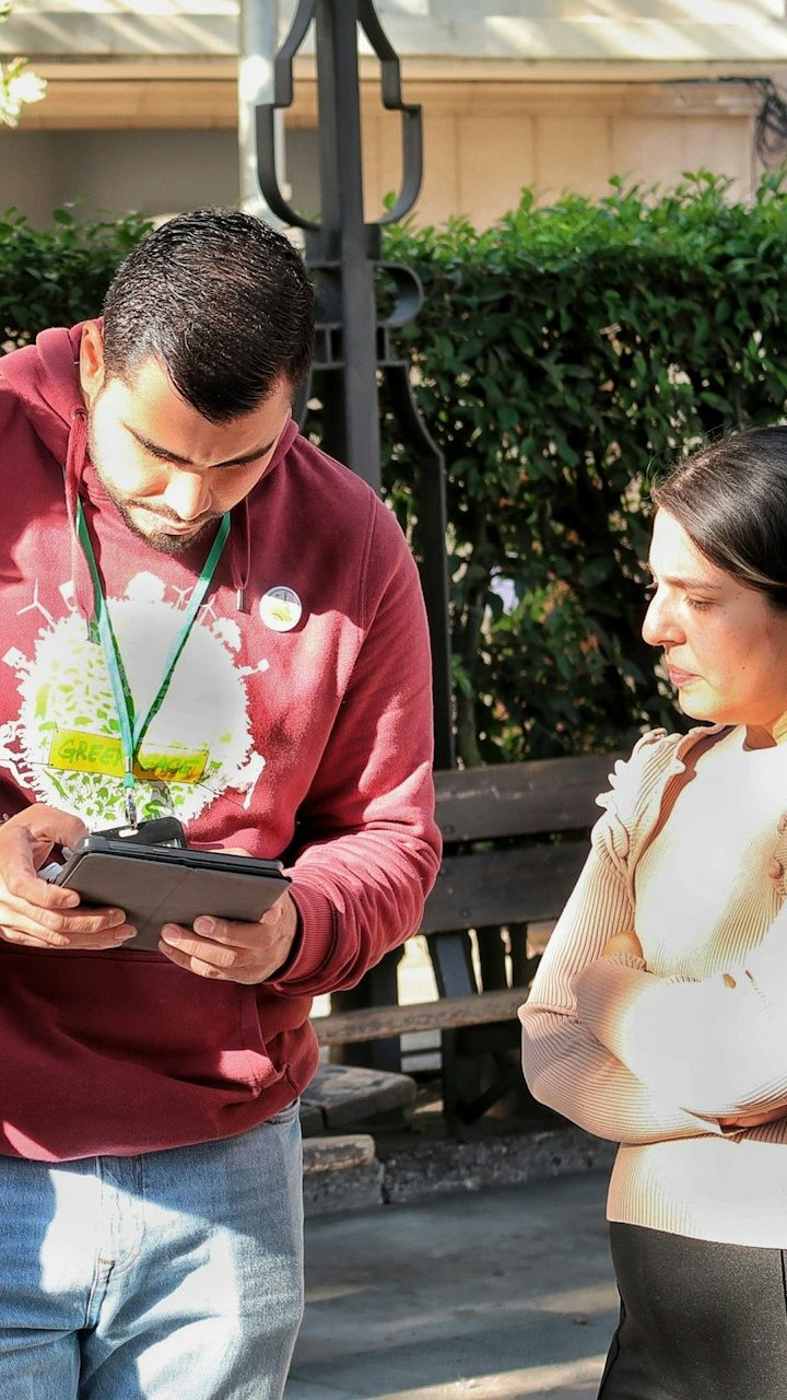 Man showing a tablet to a woman